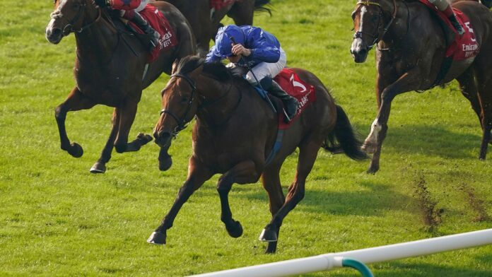 NEWMARKET, ENGLAND - OCTOBER 09: William Buick riding Coroebus (blue) win The Emirates Autumn Stakes at Newmarket Racecourse on October 09, 2023 in Newmarket, England. (Photo by Alan Crowhurst/Getty Images)