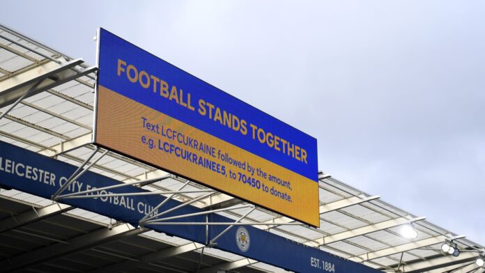 Screens display the message &#39;Football Stands Together&#39;