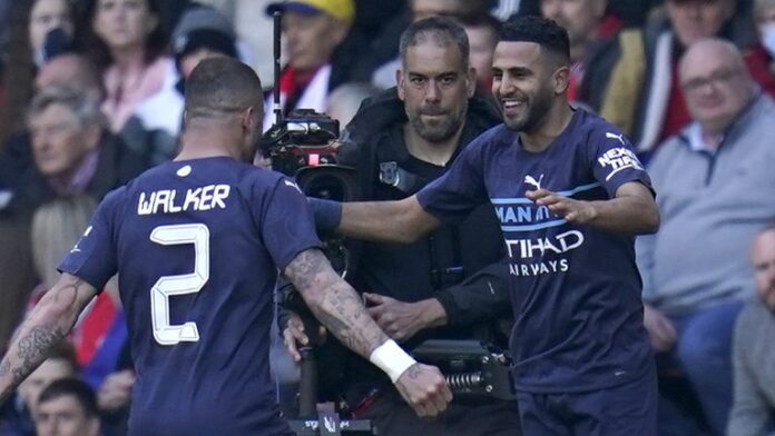 Riyad Mahrez (right) Manchester City celebrates scoring his team's fourth goal in the match