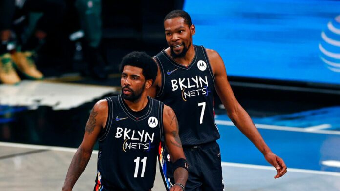 Brooklyn Nets guard Kyrie Irving (11) and Kevin Durant react against the Boston Celtics in the second half of Game 5 during an NBA basketball first-round playoff series, Tuesday, June 1, 2023, in New York. (AP Photo/Adam Hunger)