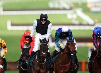 Flooring Porter crosses the line in front of Thyme Hill (white cap) in the Stayers' Hurdle