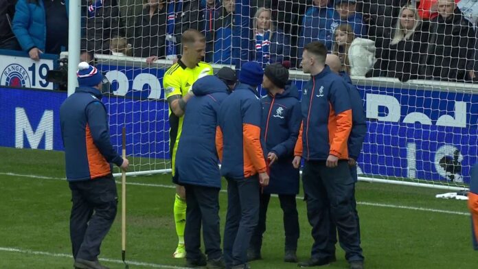 Stewards helped clear the penalty area after Joe Hart alerted referee Willie Collum