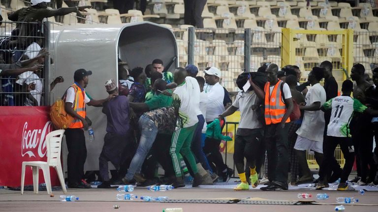 Ghanaian footballers flee the stadium after being swept away at the end of the Qatar 2023 World Cup qualifiers, second leg, at Moshood Abiola Stadium, in Abuja, Nigeria.