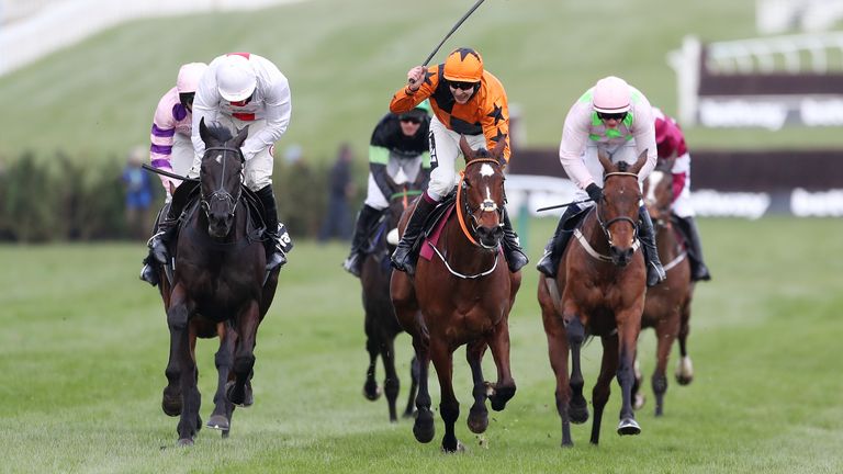 Put The Kettle (orange and black) on Nube Negra (left) to win the Queen Mother Chase Championship at Cheltenham in March