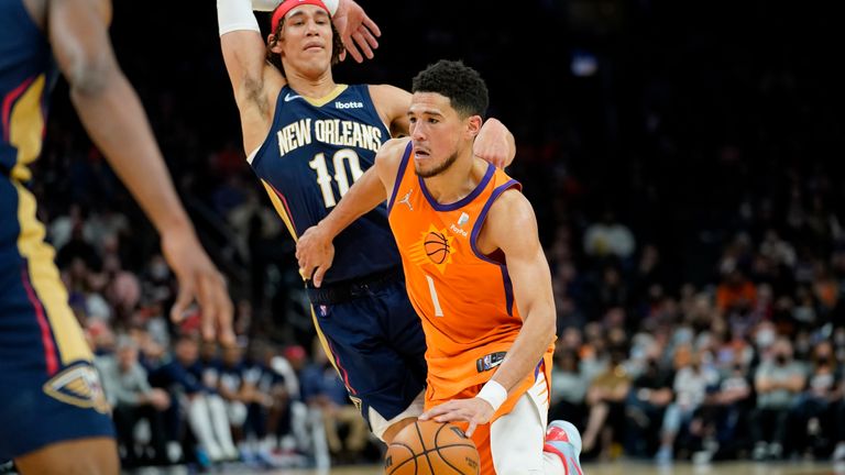 Phoenix Suns guard Devin Booker leads the New Orleans Pelicans center during the second half of an NBA basketball game, Friday, February 25, 2023, in Phoenix. 
