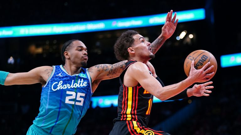 Atlanta Hawks goalkeeper Trae Young leads past Charlotte Hornets forward PJ Washington