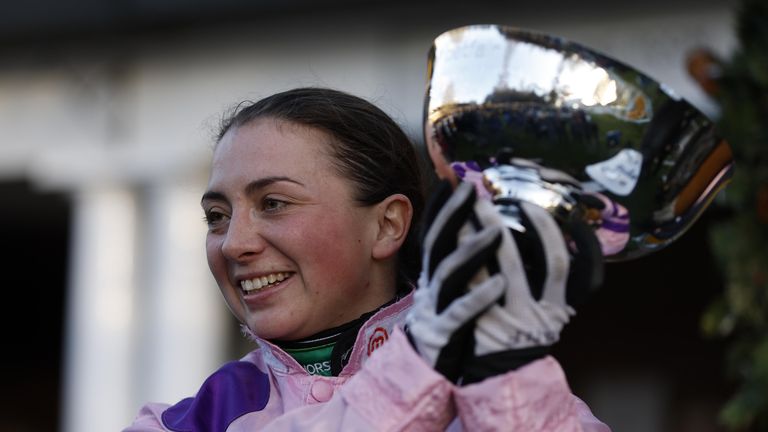 Bryony Frost holds the Tingle Creek Cup aloft at Sandown