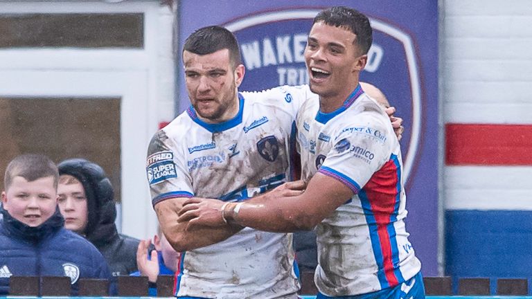 Wakefield's Corey Hall (R) is congratulated for scoring an attempt against Hull FC 
