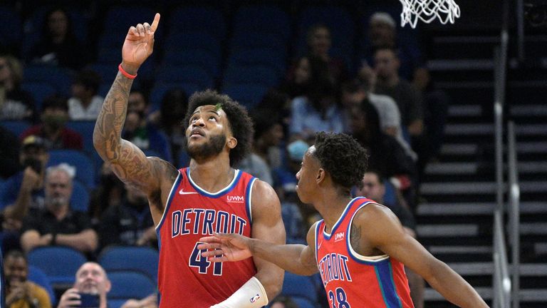 Detroit Pistons forward Bey's friend responds after a free throw near the end of an NBA basketball game against the Orlando Magic as Pistons guard Sabine Lee congratulates him.