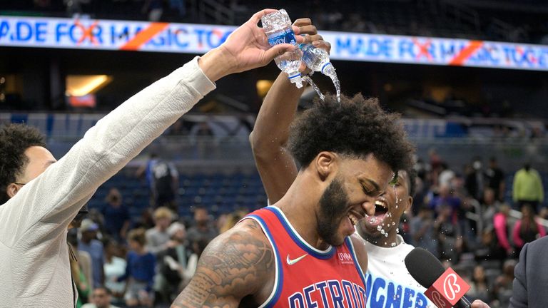 Detroit Pistons forward Sadiq Bey is drowned by teammates Cady Cunningham and Hamidou Diallo after scoring 51 points in the team's NBA basketball game against the Orlando Magic