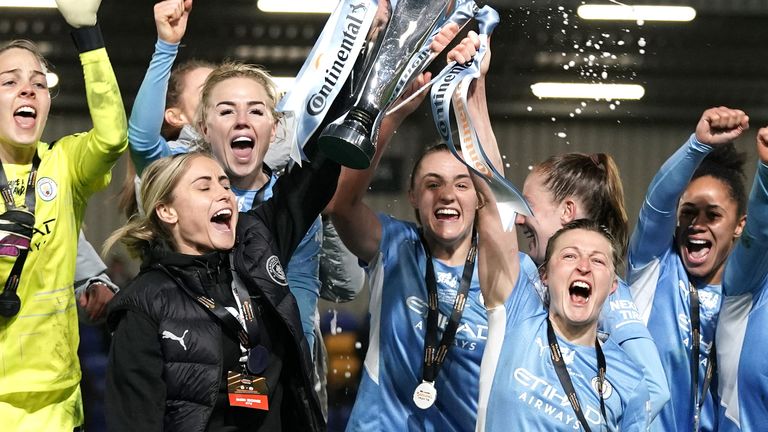 Ellen White Manchester City (right) lifts the trophy with Steve Houghton as the players celebrate their victory in the Women's Confederation Tire Association Cup