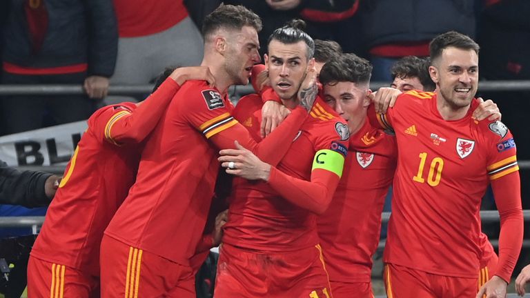 Gareth Bale celebrates with his Wales teammates after his amazing free kick against Austria