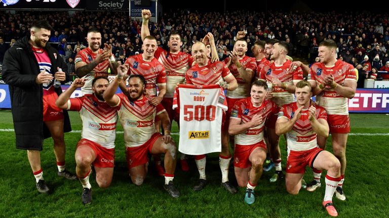 James Robbie celebrates with his St Helens teammates and fans after his 500th appearance for the club