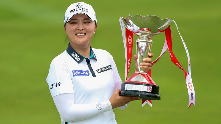 Jin Young-koo of South Korea holds the championship trophy after winning the Women's World Championships at Sentosa Golf Club in Singapore