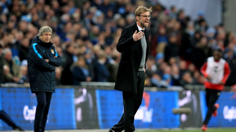 Liverpool manager Jurgen Klopp instructs his team as Manchester City manager Manuel Pellegrini (left) looks back during the 2016 FA Cup Final at Wembley Stadium in London.