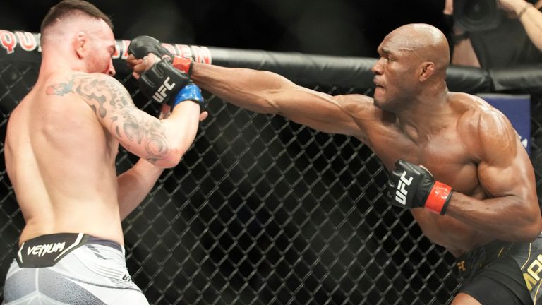 Camaro Usman (Grey Trunks) punches Colby Covington (White Trunks) in the UFC Lightweight Championship match during UFC 268: Usman vs. Covington 2 event on November 6, 2023,