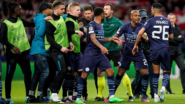Fernandinho Manchester City (second on the right) interferes between Atletico Madrid coach Diego Simeone (centre) and Riyad Mahrez at the end of the UEFA Champions League quarter-final, the return match at the Wanda Metropolitano Stadium, Madrid.  Picture date: Wednesday, April 13, 2023.