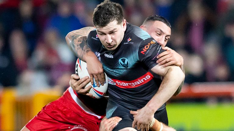 Mark Percival fights off through the interference of Elliot Minchella from Hull KR