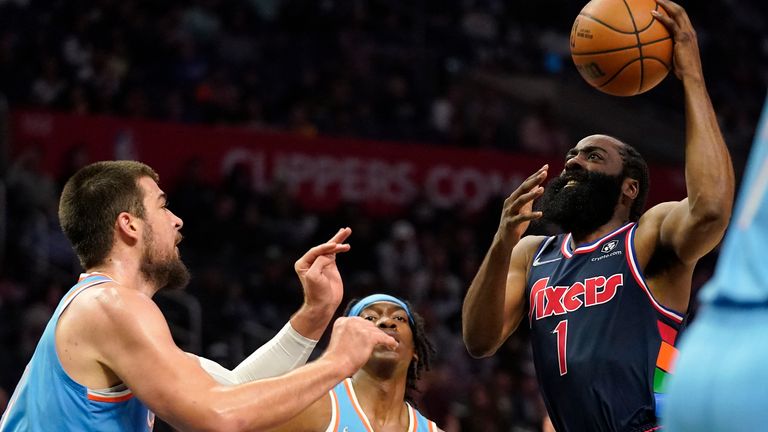 Philadelphia 76ers guard James Harden, right, shoots at Los Angeles Clippers center Ivica Zupak, left, and defends guard Terrence Mann during the second half of an NBA basketball game Friday, March 25, 2023, in Los Angeles.  (AP Photo/Mark J. Terrill)
