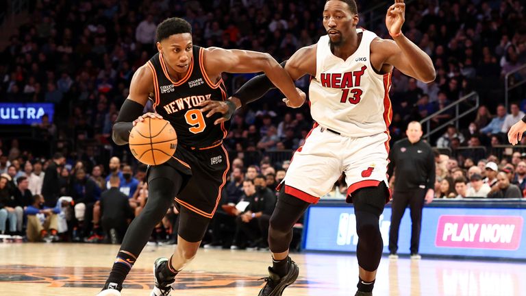 New York Knicks guard RJ Barrett dribbling against Miami Heat center Pam Adebayo during the second half of an NBA basketball game, Friday, Feb. 25, 2023, in New York. 