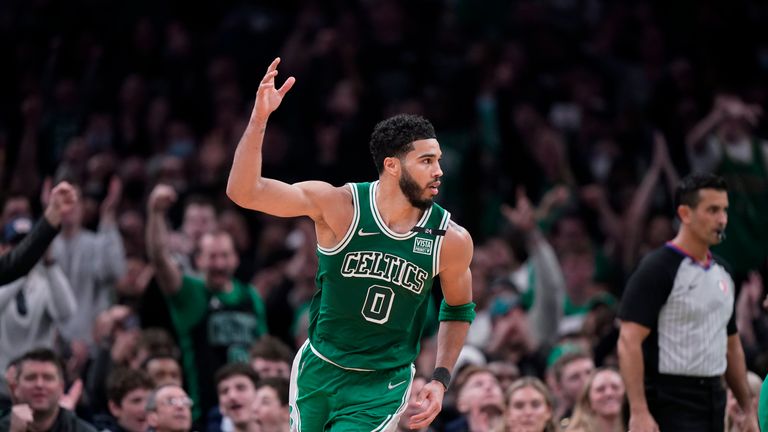Boston Celtics forward Jason Tatum (0) raises his arm after scoring in the second inning of an NBA basketball game against the Brooklyn Nets, Sunday, March 6, 2023, in Boston.  The Celtics beat the Nets 126-120.  (AP Photo/Steven Senne)