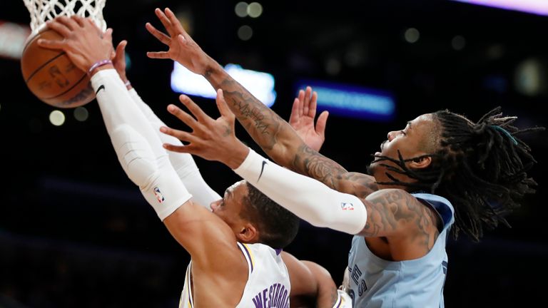 Los Angeles Lakers guard Russell Westbrook, left, grabs a rebound in front of Memphis Grizzlies guard Ja Morant, right, during the first half of an NBA basketball game Sunday, Jan. 9, 2023 in Los Angeles.  (AP Photo/Alex Gallardo)