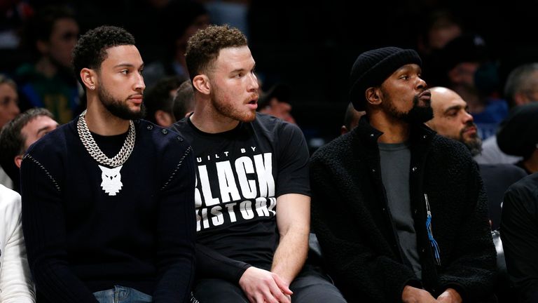 Brooklyn Nets watch Ben Simmons, Blake Griffin and Kevin Durant (7) play the Boston Celtics from the bench, during the first half of an NBA basketball game, Thursday, Feb. 24, 2023 in New York.  (AP Photo/Noah K. Murray).                                                                           