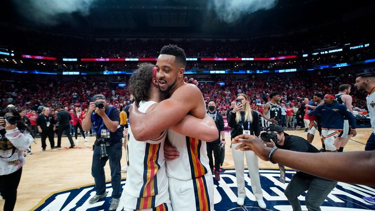 New Orleans Pelicans guard CJ McCollum hugs Jose Alvarado after the San Antonio Spurs defeat.