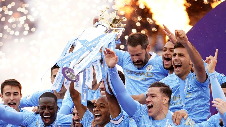 Man City captain Fernandinho lifts the PL trophy. 