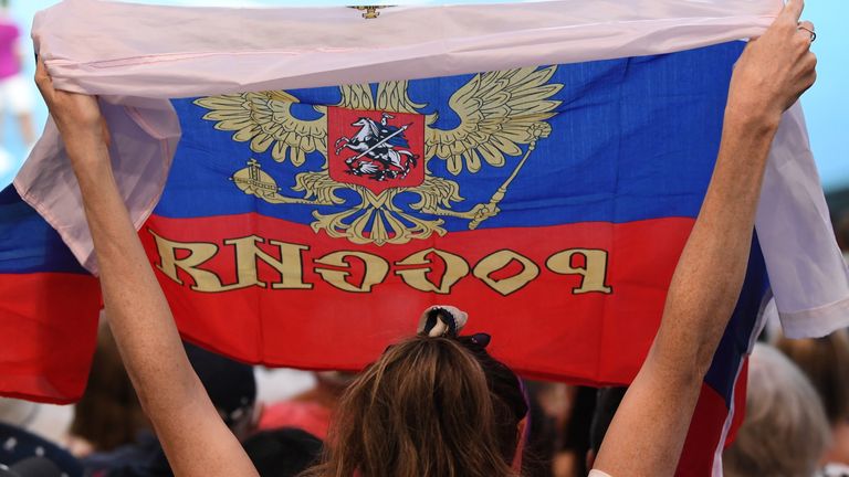 Fans wave the Russian flag at Rod Laver Arena during the men's singles final match between Rafael Nadal of Spain and Daniil Medvedev of Russia during day 14 of the 2023 Australian Open at Melbourne Park on January 30, 2023 in Melbourne, Australia.