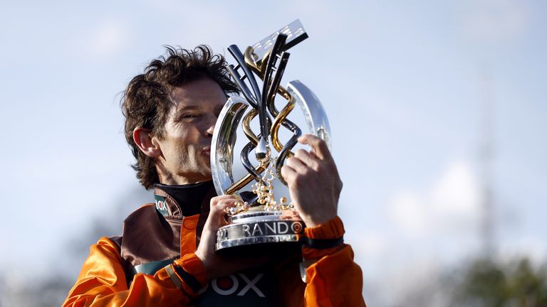 Sam Willie Cohen accepts the Grand National trophy after winning the Noble Yates