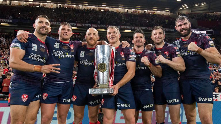 Trio: St Helen captain James Robbie lifts the 2023 Premier League trophy for the third year in a row alongside teammates Jonny Lomax, Morgan Knowles, Lachlan Cote, Mark Percival, Tommy Mackinson and Alex Walshmali