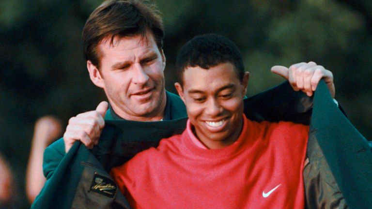 Woods received his first green jacket by Nick Faldo in 1997