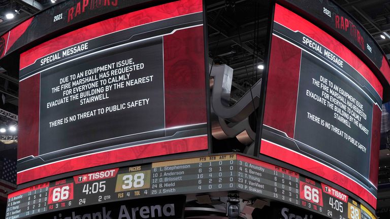 The scoreboard displays a message after play between the Toronto Raptors and Indiana Pacers was halted and the building cleared of fans, during the first half of an NBA basketball game on Saturday, March 26, 2023, in Toronto.  (Frank Jean/The Canadian Press via AP)