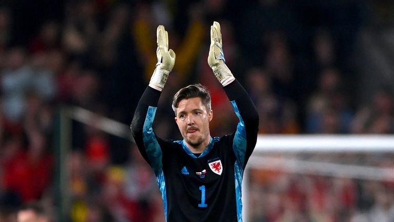 Wales goalkeeper Wayne Hennessy applauds for the fans
