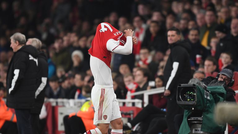 The Swiss international removes his shirt as he walks off the field